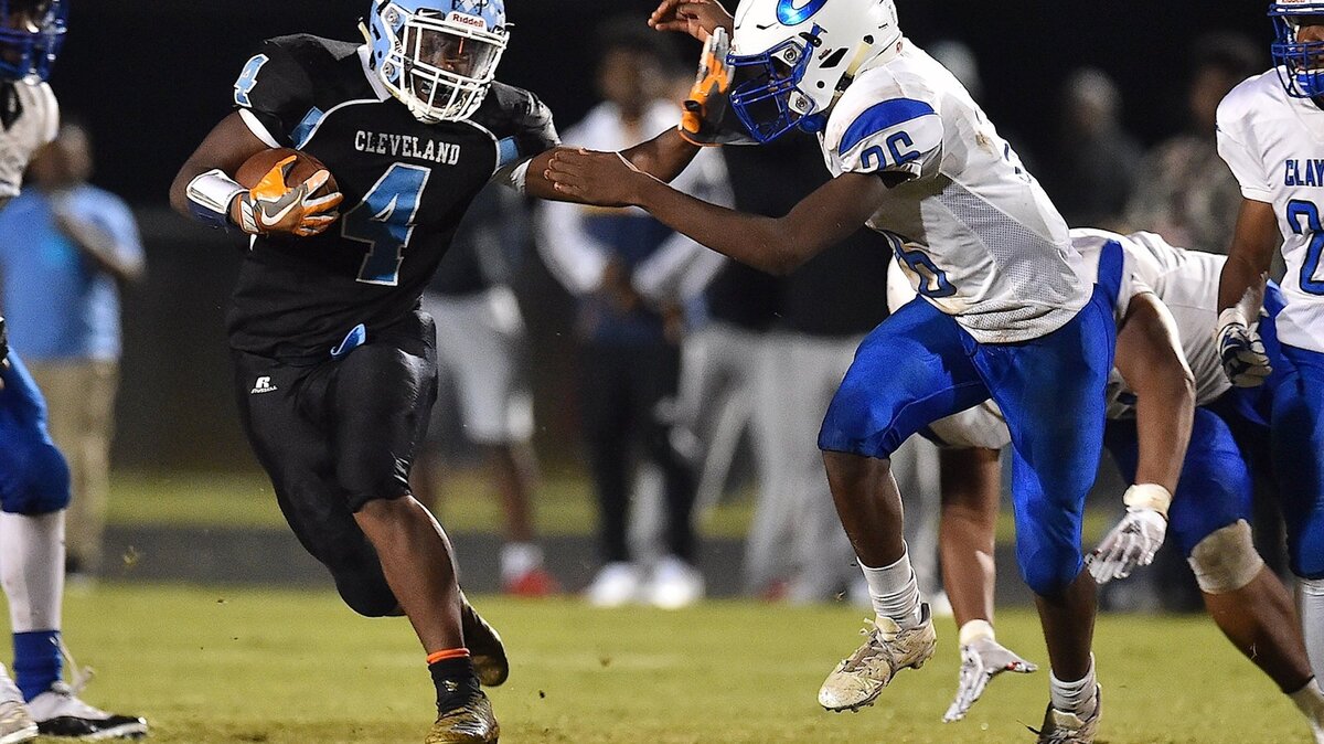 Cleveland’s Tyson Dew (4) runs for yardage against Clayton’s Isaiah Manahga (26) during the fourth quarter. The Clayton Comets and Cleveland Rams met in a regular season Greater Neuse River conference game in Clayton N.C. on October 19, 2018.