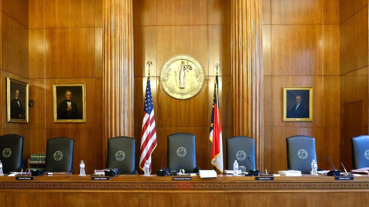 Portraits of former chief justices line the wall in the courtroom of the Supreme Court of North Carolina in Raleigh, N.C., Monday, May 9, 2022.