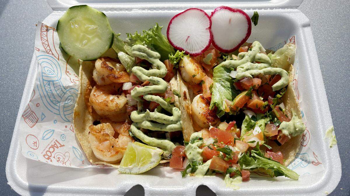 Two G’s tacos featuring grilled shrimp on handmade corn tortilla, topped with organic spring mix, housemade avocado cream, pico de gallo, & chipotle mayo.