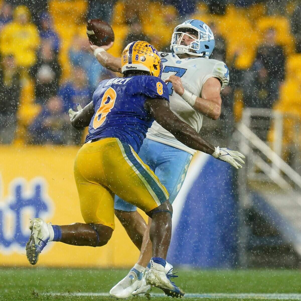 North Carolina quarterback Sam Howell drops back to pass as Pittsburgh defensive lineman Calijah Kanceys closes in on the last play of the NCAA college football game, Thursday, Nov. 11, 2021, in Pittsburgh. Pittsburgh won in overtime. (Matt Freed/Pittsburgh Post-Gazette via AP)
