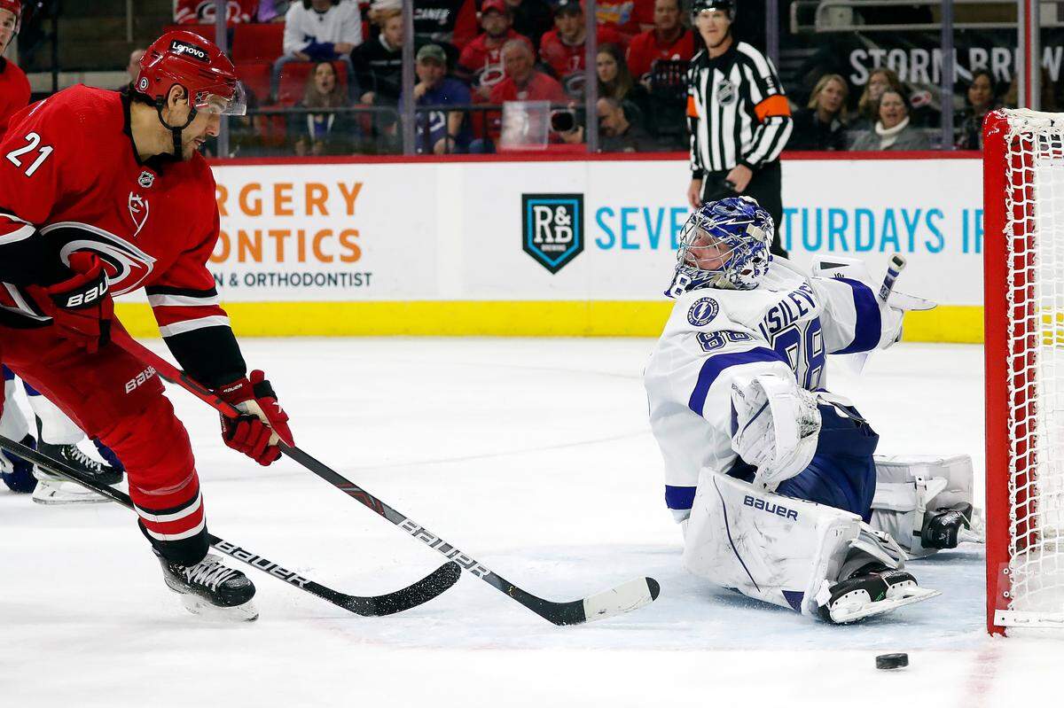 Carolina Hurricanes’ Nino Niederreiter (21) has his shot go wide of Tampa Bay Lightning goaltender Andrei Vasilevskiy (88) during the second period of an NHL hockey game in Raleigh, N.C., Tuesday, March 22, 2022. (AP Photo/Karl B DeBlaker)