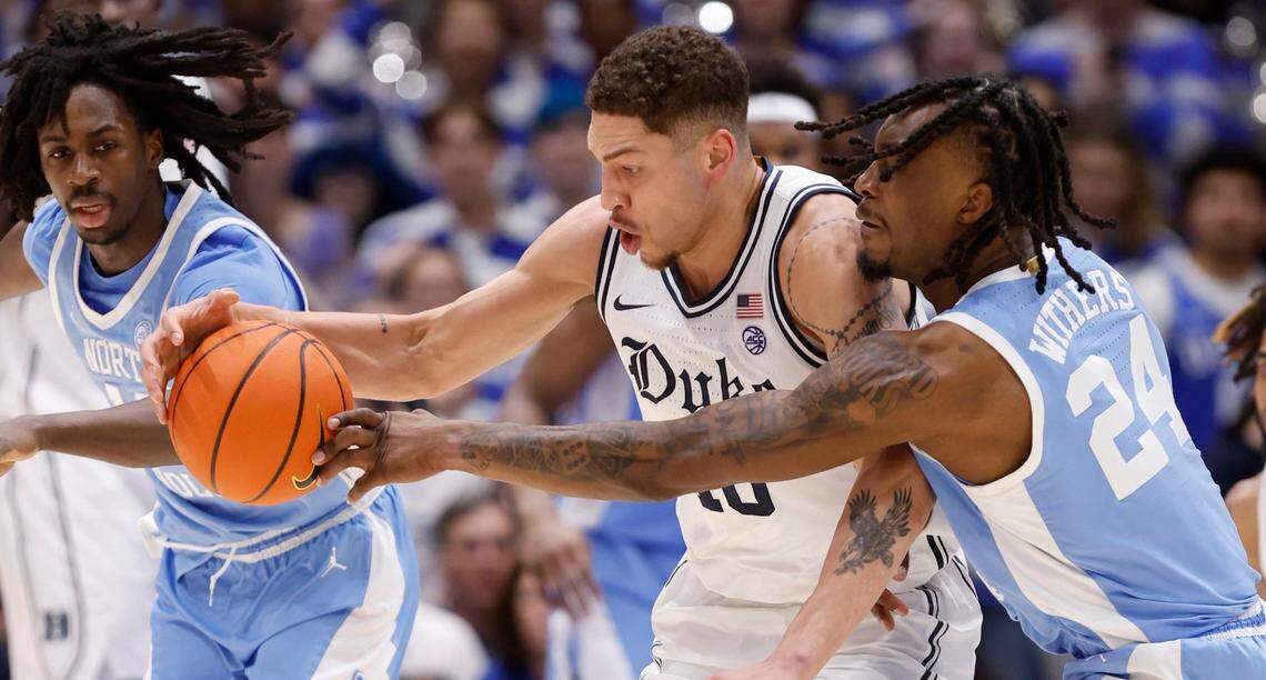 Duke’s Mason Gillis (18) and North Carolina’s Jae’Lyn Withers (24) go after the ball during the first half of Duke’s game against UNC at Cameron Indoor Stadium in Durham, N.C., Saturday, Feb. 1, 2025.