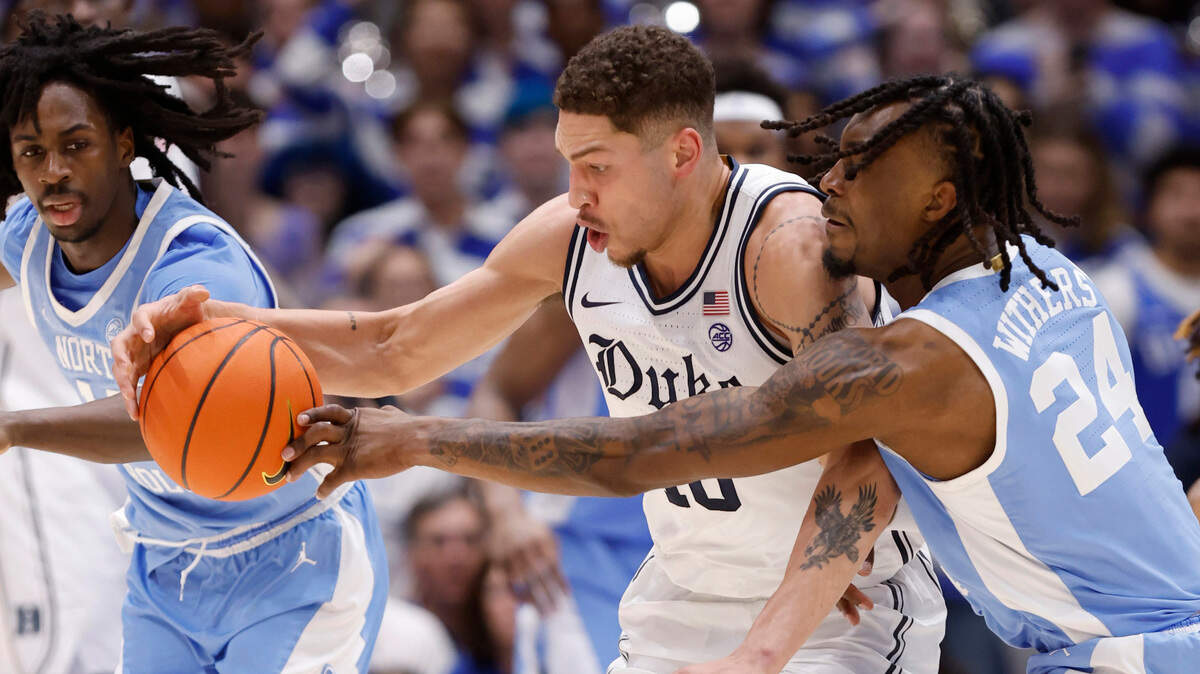 Duke’s Mason Gillis (18) and North Carolina’s Jae’Lyn Withers (24) go after the ball during the first half of Duke’s game against UNC at Cameron Indoor Stadium in Durham, N.C., Saturday, Feb. 1, 2025.