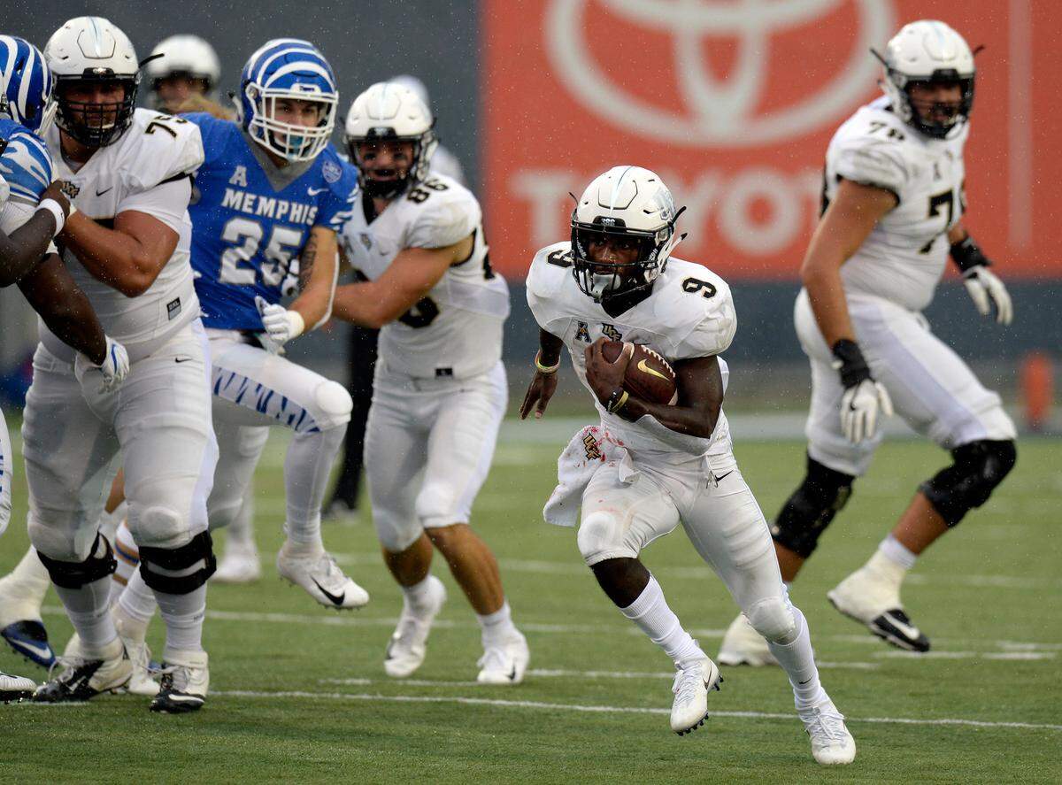 Central Florida running back Adrian Killins Jr. (9) runs the ball against Memphis during the second half of an NCAA college football game Saturday, Oct. 13, 2018, in Memphis, Tenn. Central Florida won 31-30. (AP Photo/Mark Zaleski)