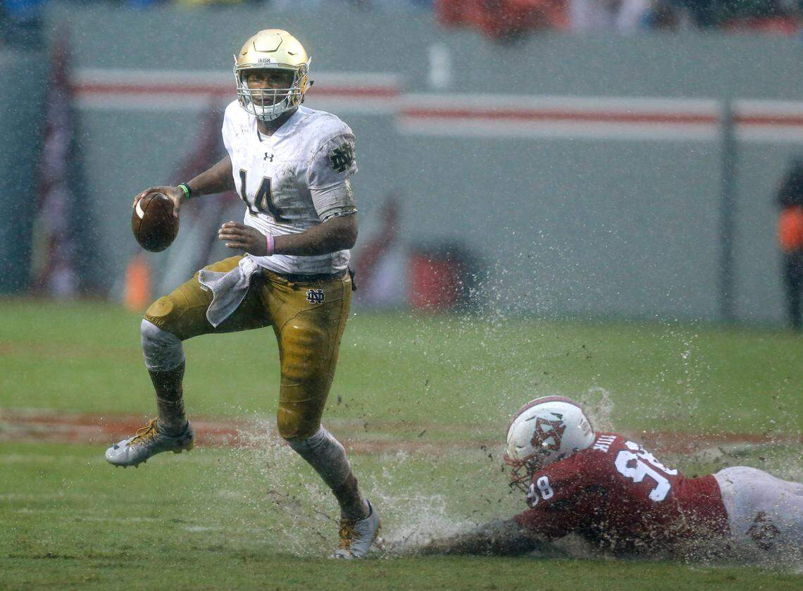Notre Dame quarterback DeShone Kizer (14) escapes N.C. State defensive tackle B.J. Hill (98) during the first half of the Wolfpack’s game against Notre Dame at Carter-Finley Stadium in Raleigh, N.C., Saturday, Oct. 8, 2016.