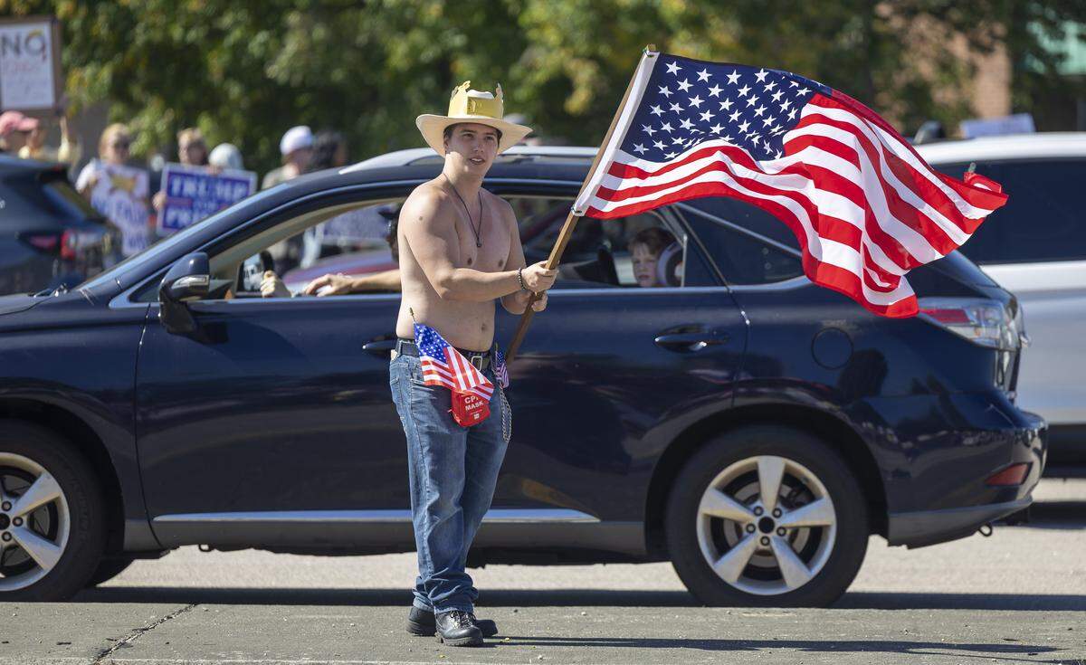 Pierce Winston of Clayton, N.C. waves his flag from the median of Capital Blvd. during the ‘No Kings’  demonstration on Saturday, October 18, 2025 in Raleigh, N.C. 