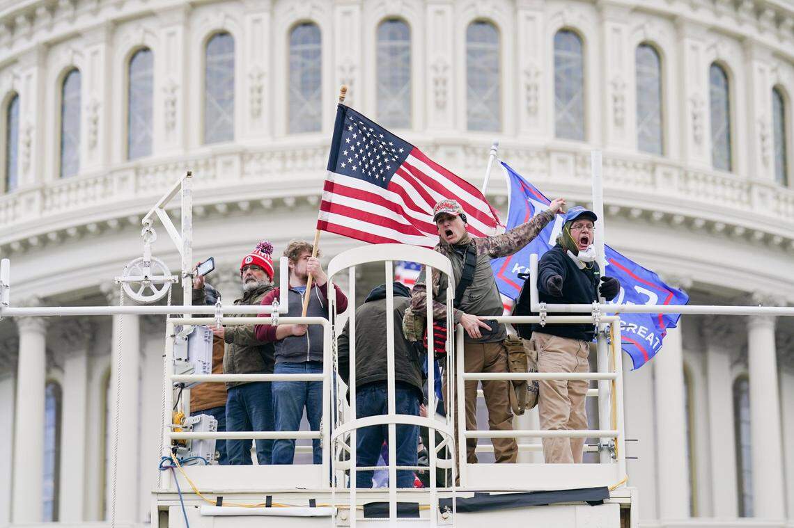Supporters loyal to President Donald Trump clash with authorities before successfully breaching the Capitol building during a riot on the grounds, Wednesday, Jan. 6, 2021. A number of lawmakers and then the mob of protesters tried to overturn America’s presidential election, undercutting the nation’s democracy by attempting to keep Democrat Joe Biden from replacing Trump in the White House.