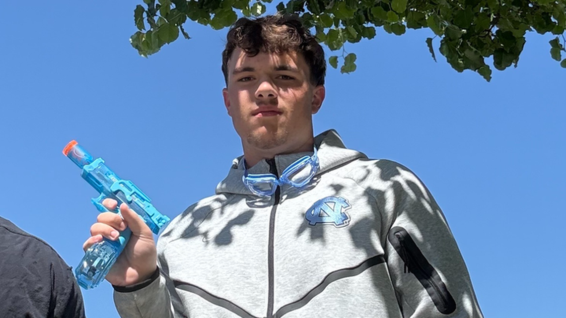 Hayden Green, a senior at Garner Magnet High School, shows off his battery-powered water gun that got him to the second round of Senior Assassin, a ritual for high school seniors.