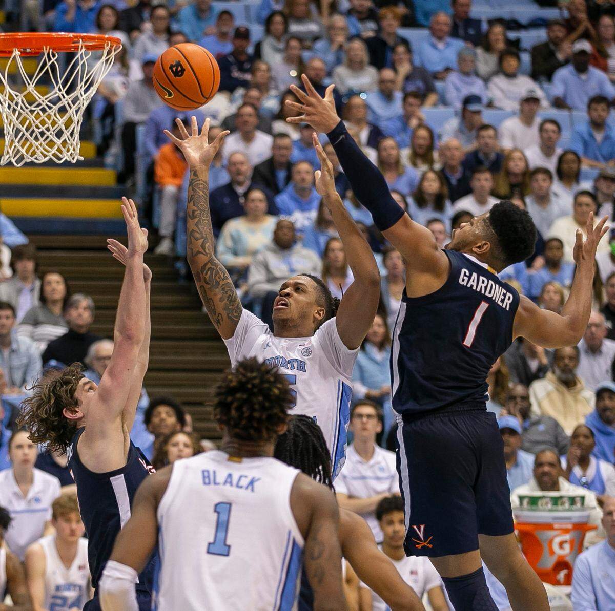 North Carolina’s Armando Bacot (5) puts up a shot against Virginia’s Ben Vander Plas (5) and Jayden Gardner (1) in the second half on Saturday, February 25, 2023 at the Smith Center in Chapel Hill, N.C.