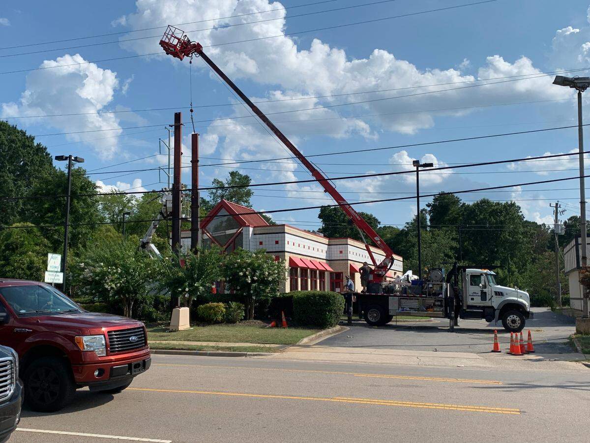 Workers dismantle the supports for the old Arby’s Roast Beef sign outside the shuttered restaurant on Hillsborough Street in Raleigh. The iconic sign was taken on July 6, 2022.