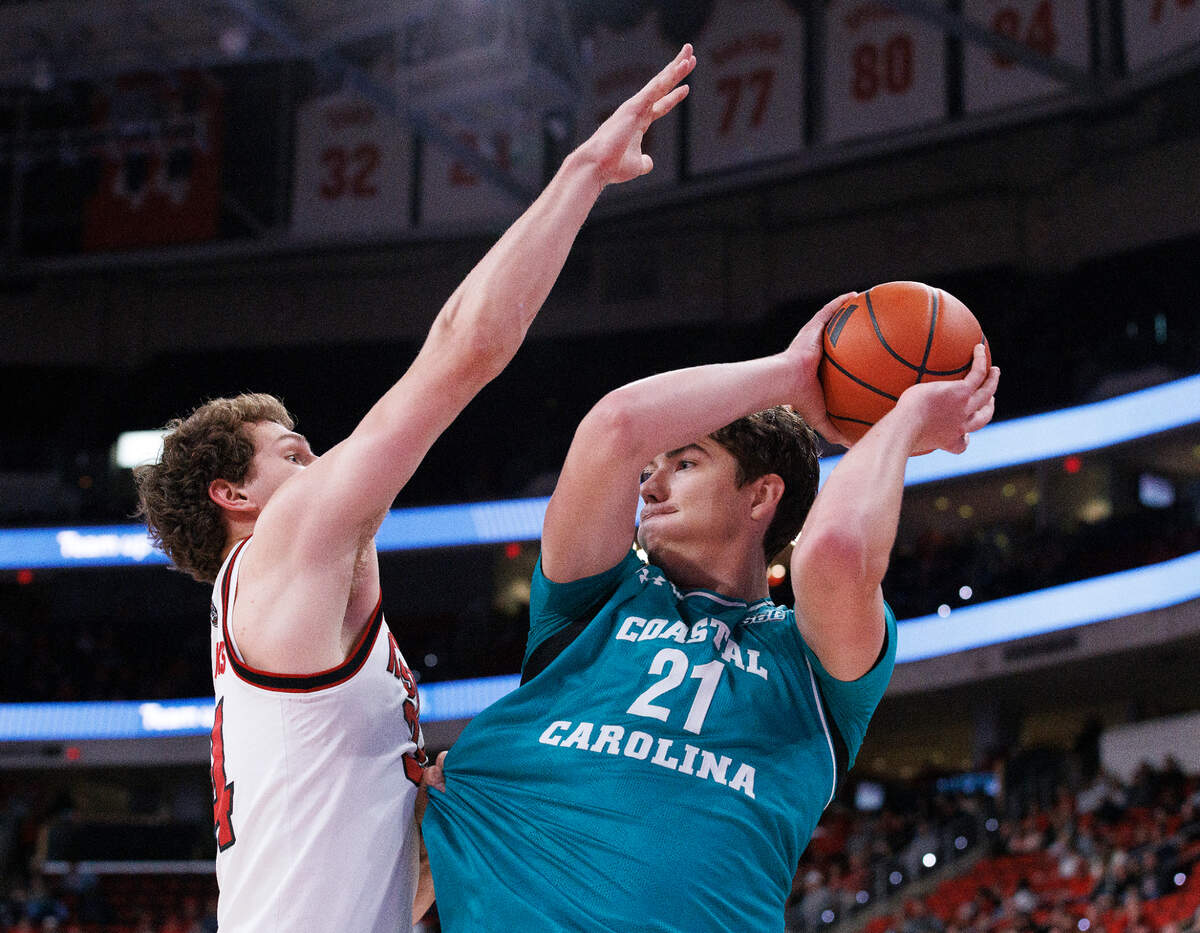 N.C. State’s Ben Middlebrooks pressures Coastal Carolina’s Noah Amenhauser during the second half of the Wolfpack’s 82-70 win on Wednesday, Nov. 13, 2024, at Lenovo Center in Raleigh, N.C.