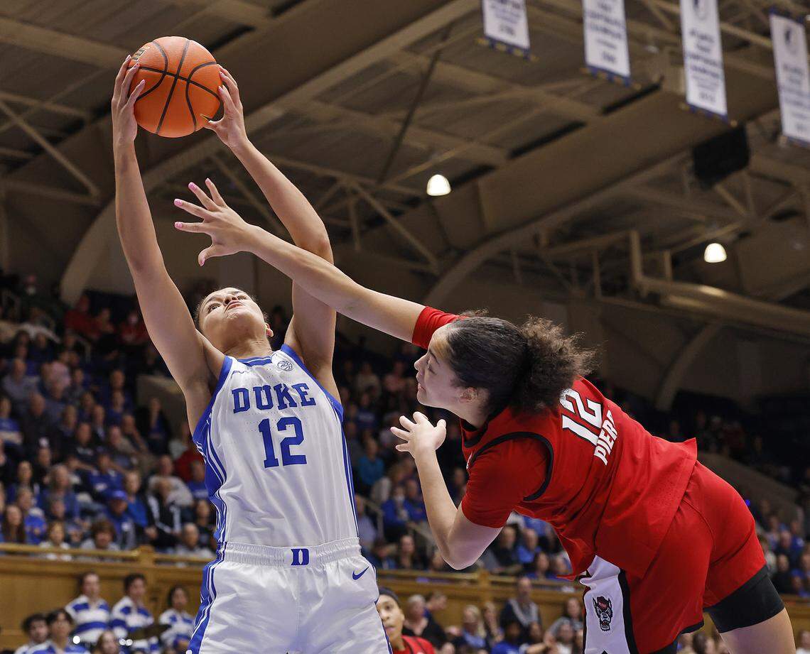 Duke’s Delaney Thomas grabs a pass over N.C. State’s Khamil Pierre during the second half of the Blue Devils’ 83-65 win on Thursday, Feb. 19, 2026, at Cameron Indoor Stadium in Durham, N.C.