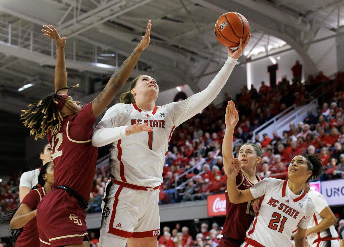 N.C. State’s River Baldwin puts up a shot around Florida State’s Sakyia White during the first half of the Wolfpack’s game on Thursday, Jan. 4, 2023, at Reynolds Coliseum in Raleigh, N.C.