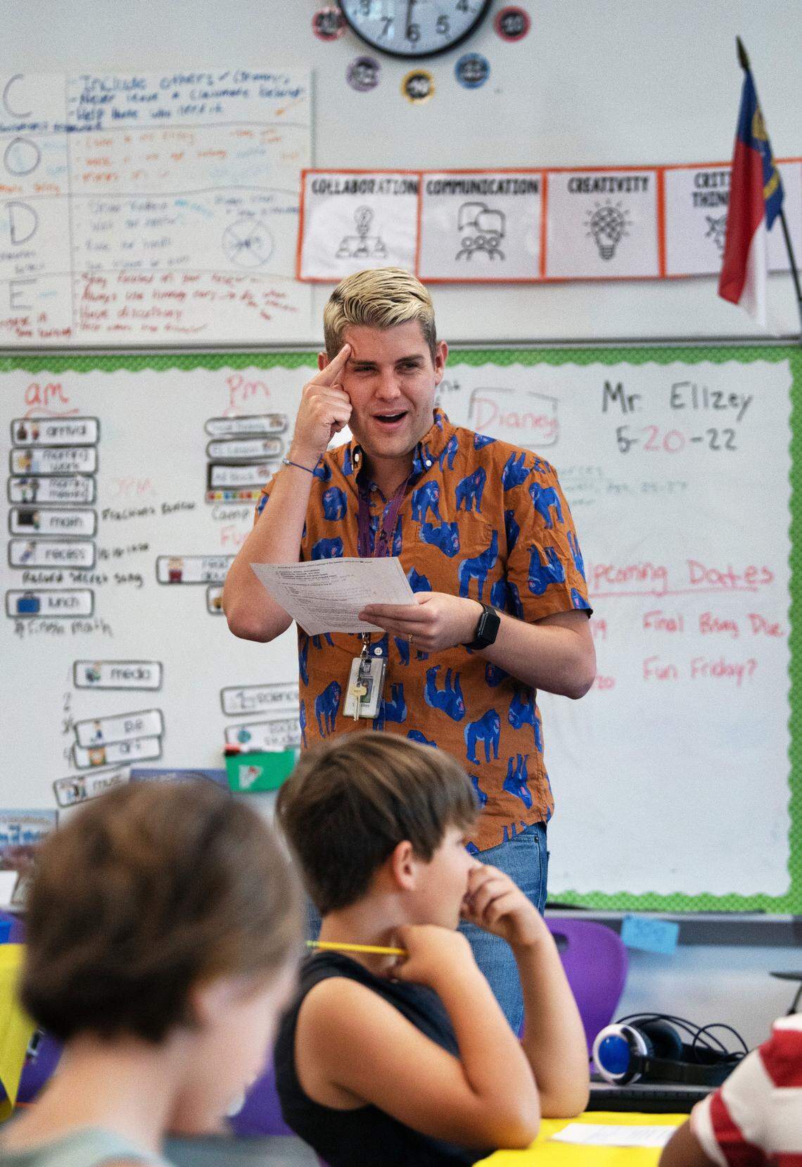 Third grade teacher Tyler Ellzey works with students on a reading comprehension exercise at Buckhorn Creek Elementary in Holly Springs, May 20, 2022.
