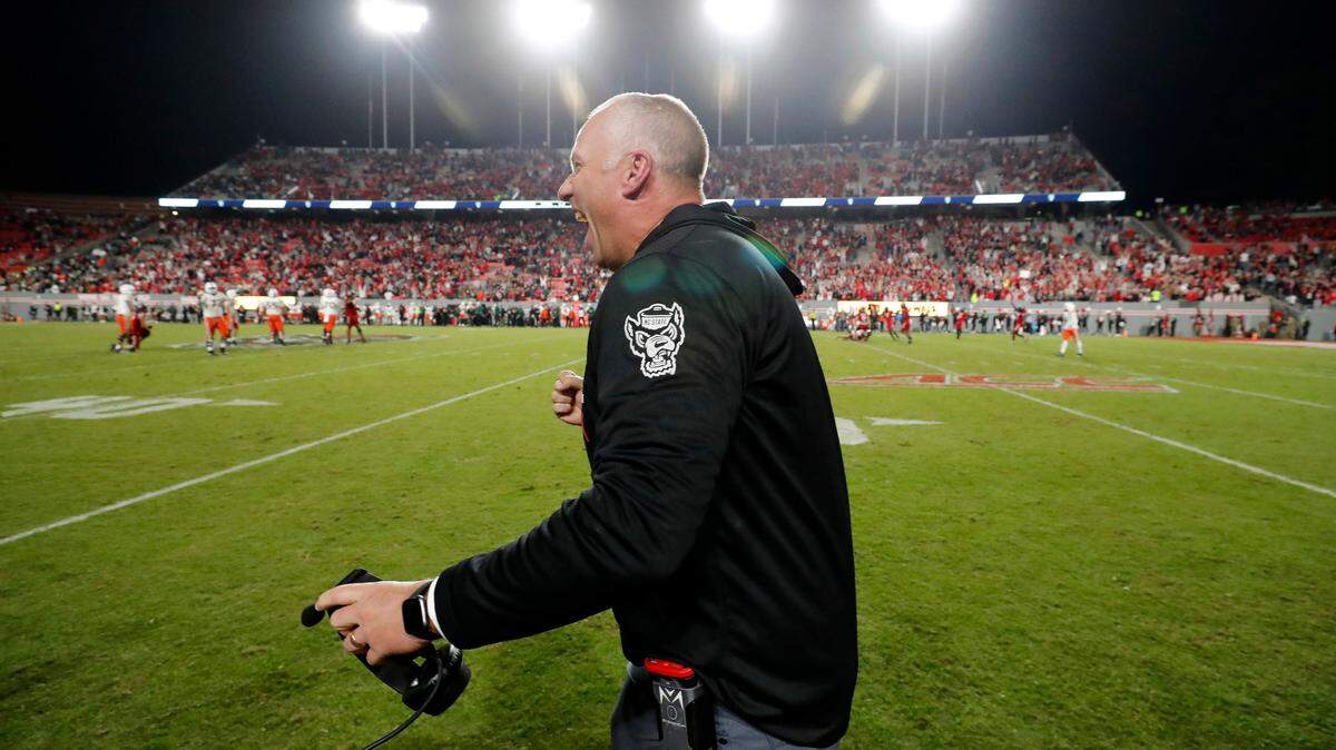 N.C. State head coach Dave Doeren celebrates as time runs out in the Wolfpack’s 20-6 victory over Miami at Carter-Finley Stadium in Raleigh, N.C., Saturday, Nov. 4, 2023. The victory makes Doeren the Pack’s the winningest coach in N.C. State history.