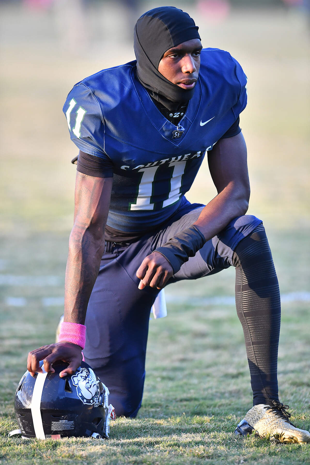 Southeast Raleigh defensive end Keysaun Eleazer (11) takes a break during pregame drills before their game with Clayton. The Southeast Raleigh Bulldogs and the Clayton Comets met in a non-conference football game in Raleigh, N.C. October 3, 2025