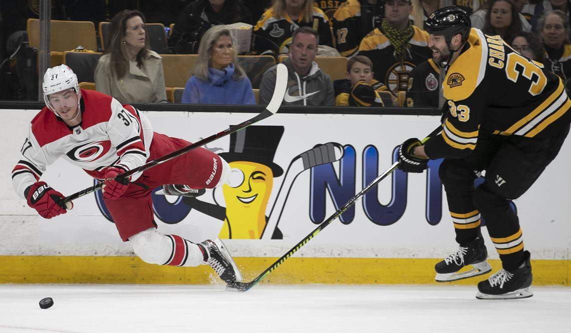 Boston’s Zendo Chara (33) trips Carolina Hurricanes’ Andrei Svechnikov (37) during the first period, and is called for a penalty during Game 2 of the Eastern Conference finals on Sunday, May 12, 2019 at TD Garden in Boston, Mass.