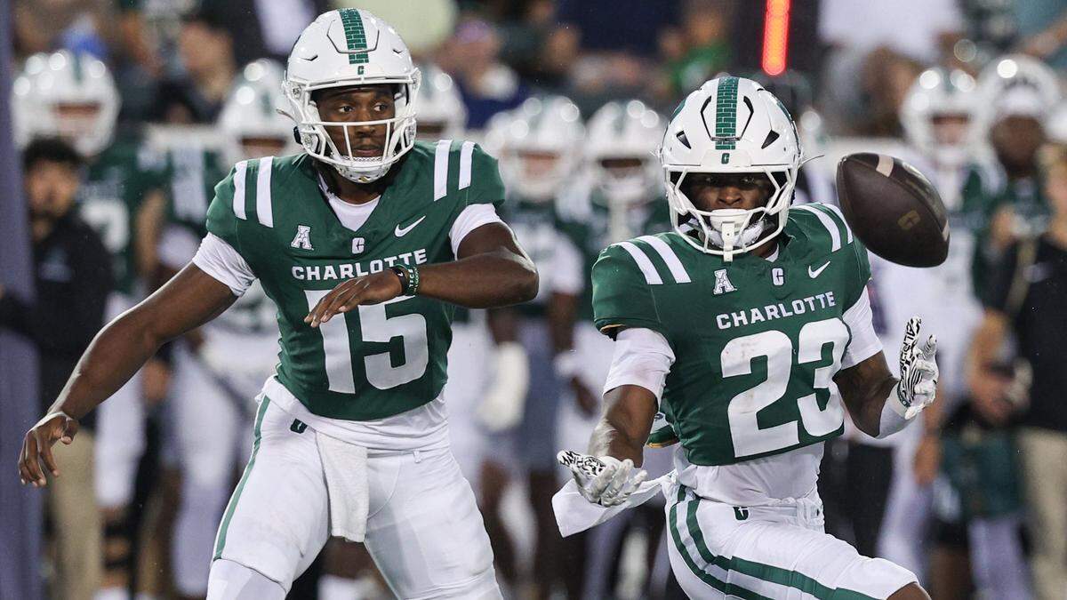 Charlotte quarterback Connor Harrell, left, and runningback CJ Stokes react as the snap is fumbled and the ball beomes loose during the game against Chapel Hill at Jerry Richardson Stadium in Charlotte on Saturday, September 6, 2025.