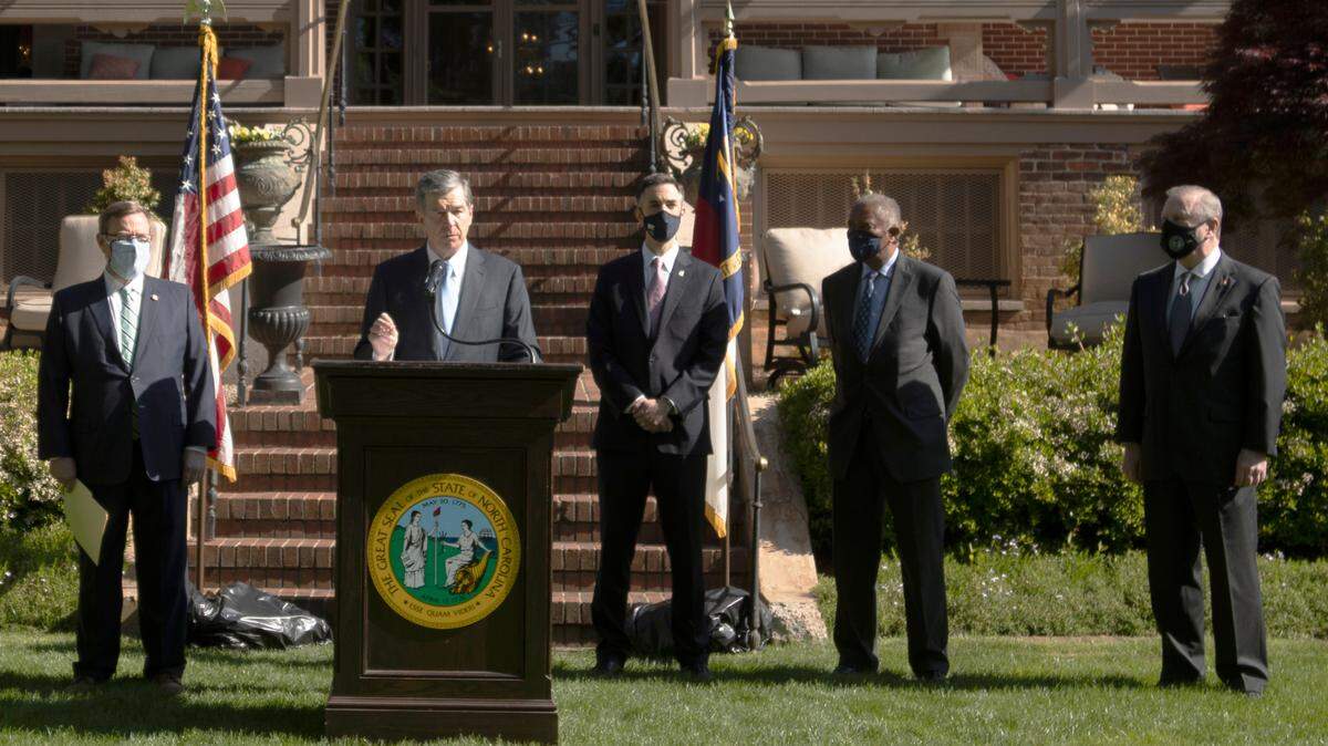 Gov. Roy Cooper announces AppleÕs new campus at Research Triangle Park. From left: House Speaker Tim Moore, Cooper, Wake Commissioner Matt Calabria, Sen. Dan Blue and Sen. Phil Berger make the announcement at a rare joint press conference held at the Executive Mansion in Raleigh Monday, , April 26, 2021.