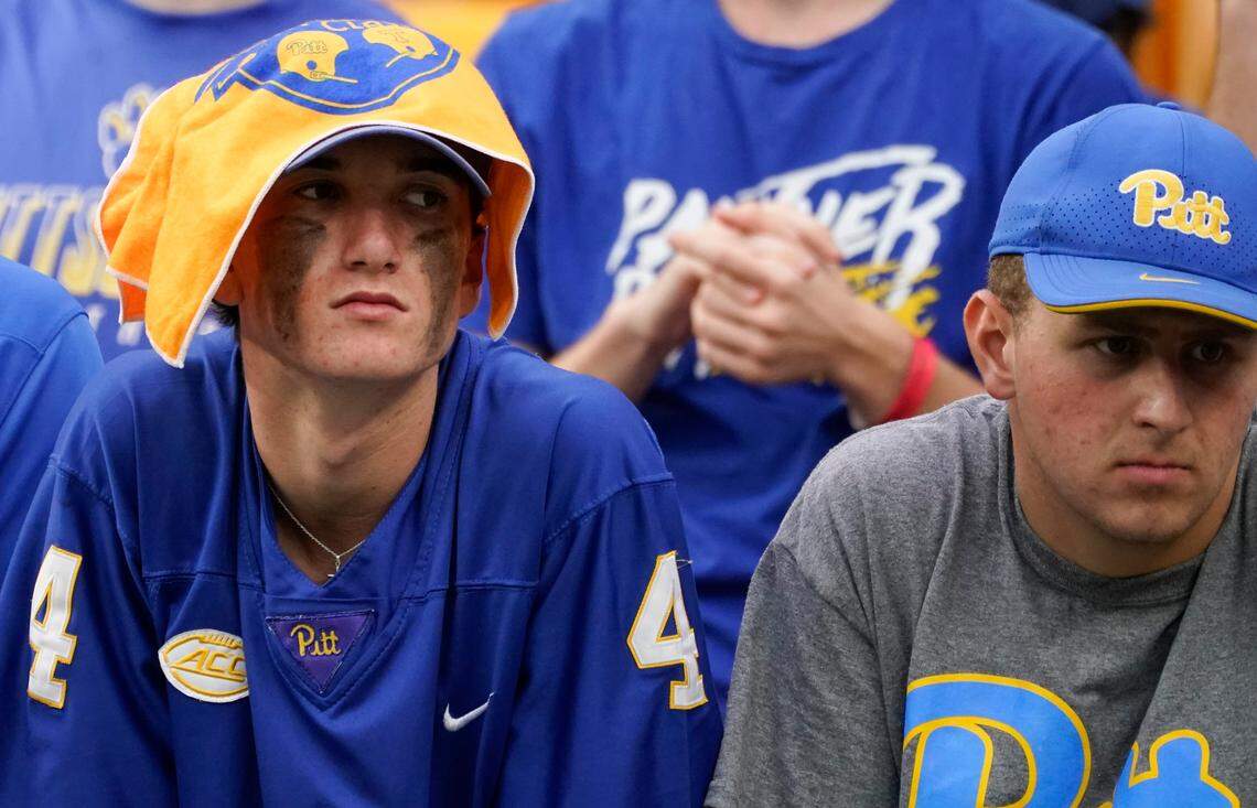 A pair of Pittsburgh fans watch as their team is losing to Tennessee during the second half of an NCAA college football game, Saturday, Sept. 10, 2022, in Pittsburgh.