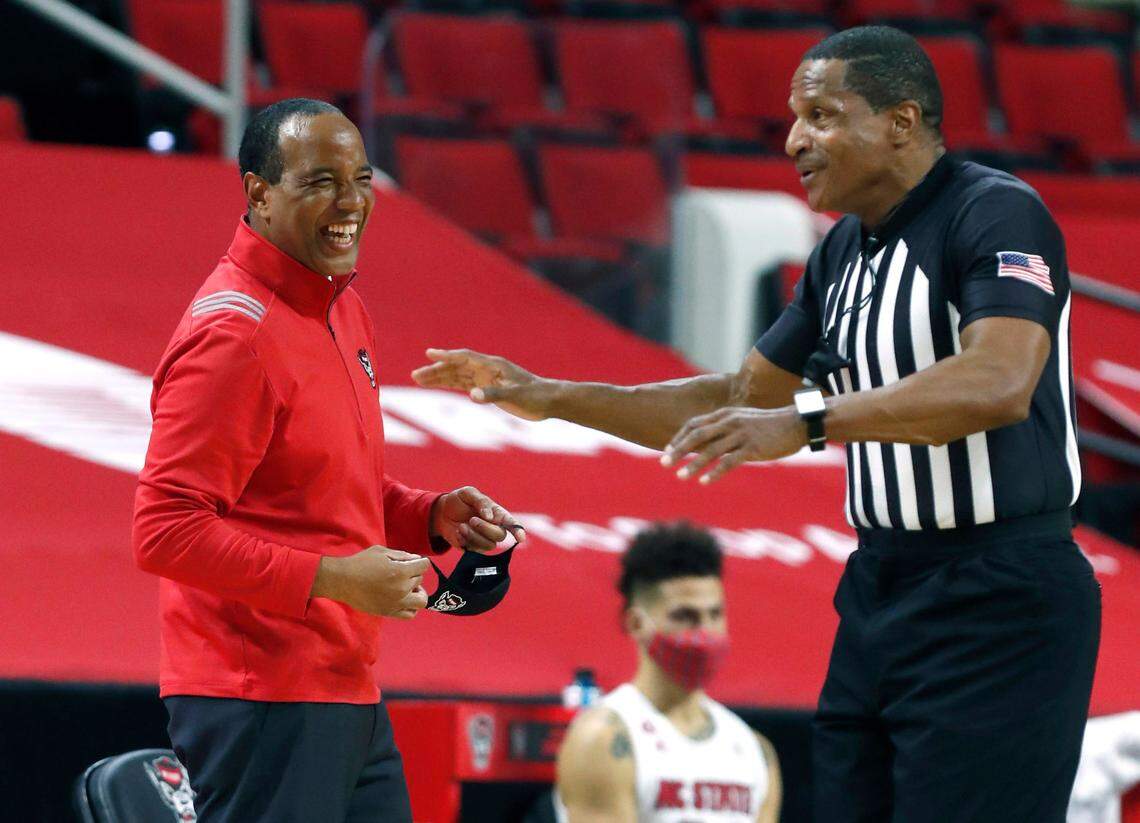 N.C. State head coach Kevin Keatts laughs at a call by official Ted Valentine during the first half of N.C. State’s game against UNC at PNC Arena in Raleigh, N.C., Tuesday, December 22, 2020.