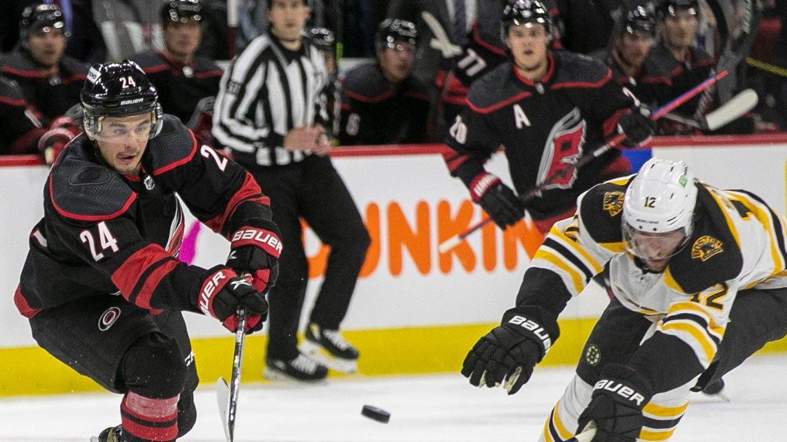Carolina Hurricanes’ Seth Jarvis (24) passes ahead of Boston’s Craig Smith (12) in the first period on Monday, May 2, 2022 during game one of their Stanley Cup first round series at PNC Arena in Raleigh, N.C.