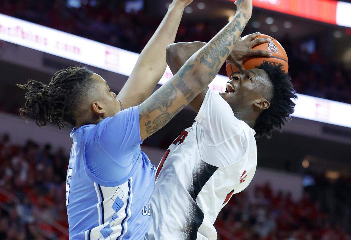 N.C. State’s Jarkel Joiner (1) heads to the basket as North Carolina’s Armando Bacot (5) defends during the second half of N.C. State’s 77-69 victory over UNC at PNC Arena in Raleigh, N.C., Sunday, Feb. 19, 2023.