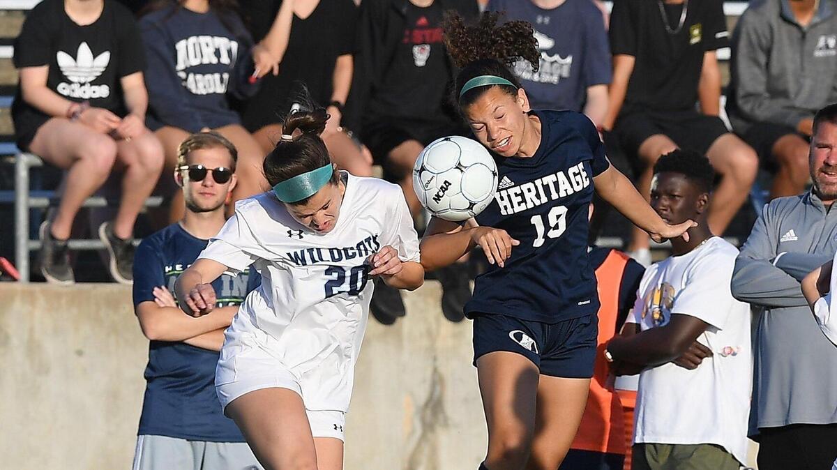 Raegan Meyer, right, of Heritage fights over a header against Kendal Powell (20) of Millbrook. The Millbrook Wildcats visited the Heritage Huskies in a high school girls soccer game on May 15, 2019.