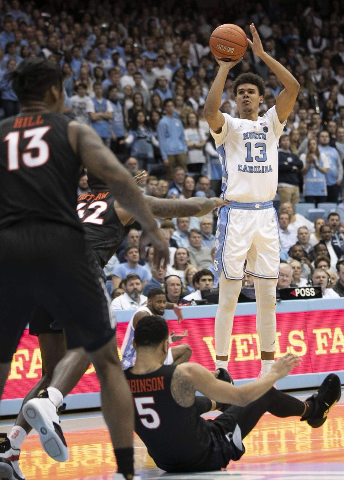 North Carolina’s Cameron Johnson (13) launches a three point shot over Virginia Tech’s Justin Robinson (5) in the second half on Monday, January 21, 2019 at the Smith Center in Chapel Hill, N.C.