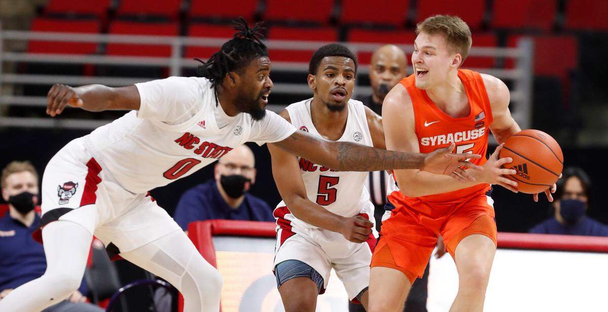 Syracuse’s Buddy Boeheim (35) keeps the ball from N.C. State’s D.J. Funderburk (0) during the second half of Syracuse’s 77-68 victory over N.C. State at PNC Arena in Raleigh, N.C., Tuesday, February 9, 2021.
