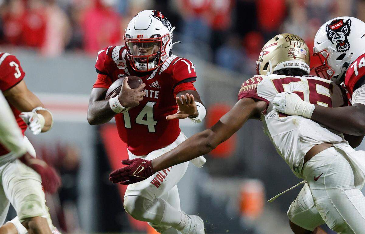 N.C. State quarterback Jack Chambers (14) rushes for yards during the second half of N.C. State’s 19-17 victory over Florida State at Carter-Finley Stadium in Raleigh, N.C., Saturday, Oct. 8, 2022.
