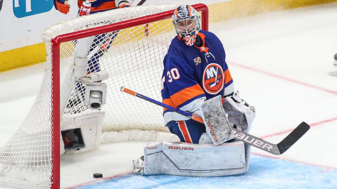The puck slides past New York Islanders goaltender Ilya Sorokin (30) for the game-wining goal in overtime in game six of the first round of the 2023 Stanley Cup Playoffs against the Carolina Hurricanes at UBS Arena.