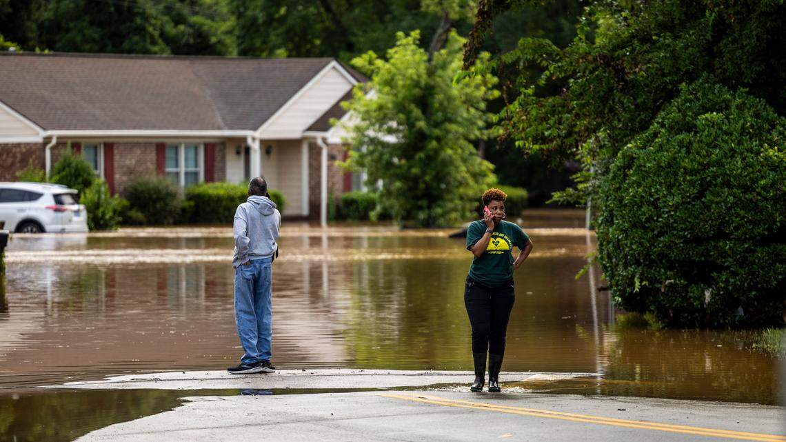 Residents assess flooding in the Old Farm neighborhood along the Eno River in Durham on Monday morning, July 7, 2025, after flash flooding caused by Tropical Storm Chantal.