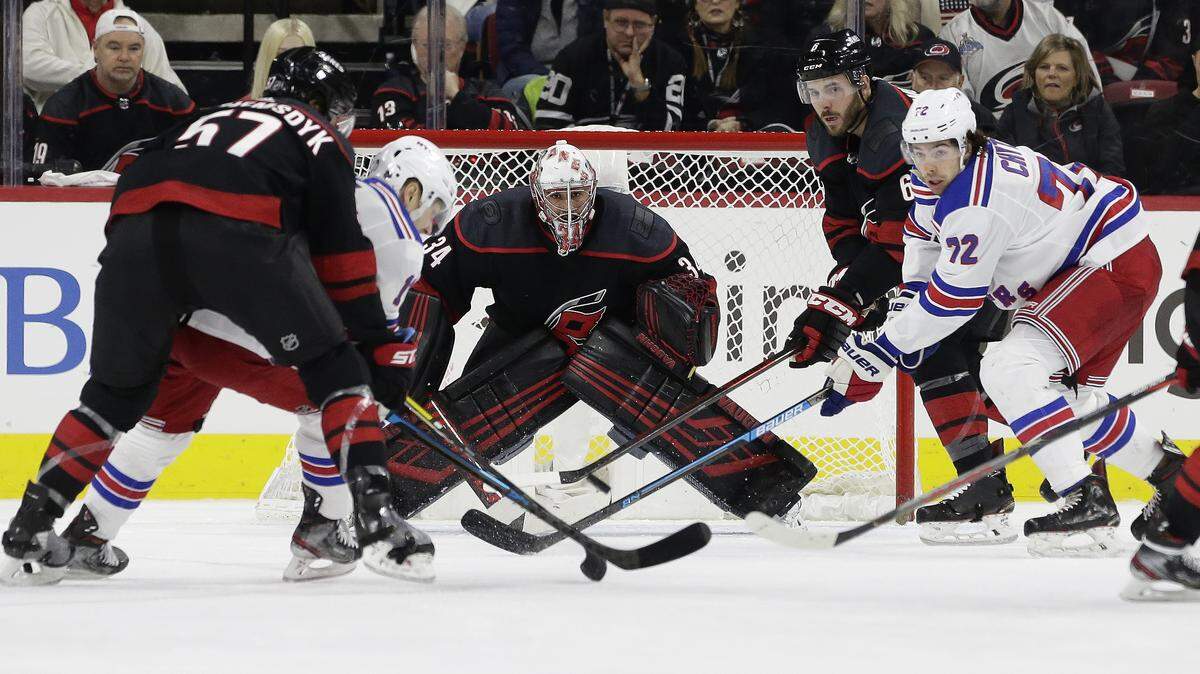 Carolina Hurricanes goaltender Petr Mrazek (34) keeps an eye on the puck during the second period of an NHL hockey game against the New York Rangers in Raleigh, N.C., Friday, Feb. 21, 2020. (AP Photo/Gerry Broome)