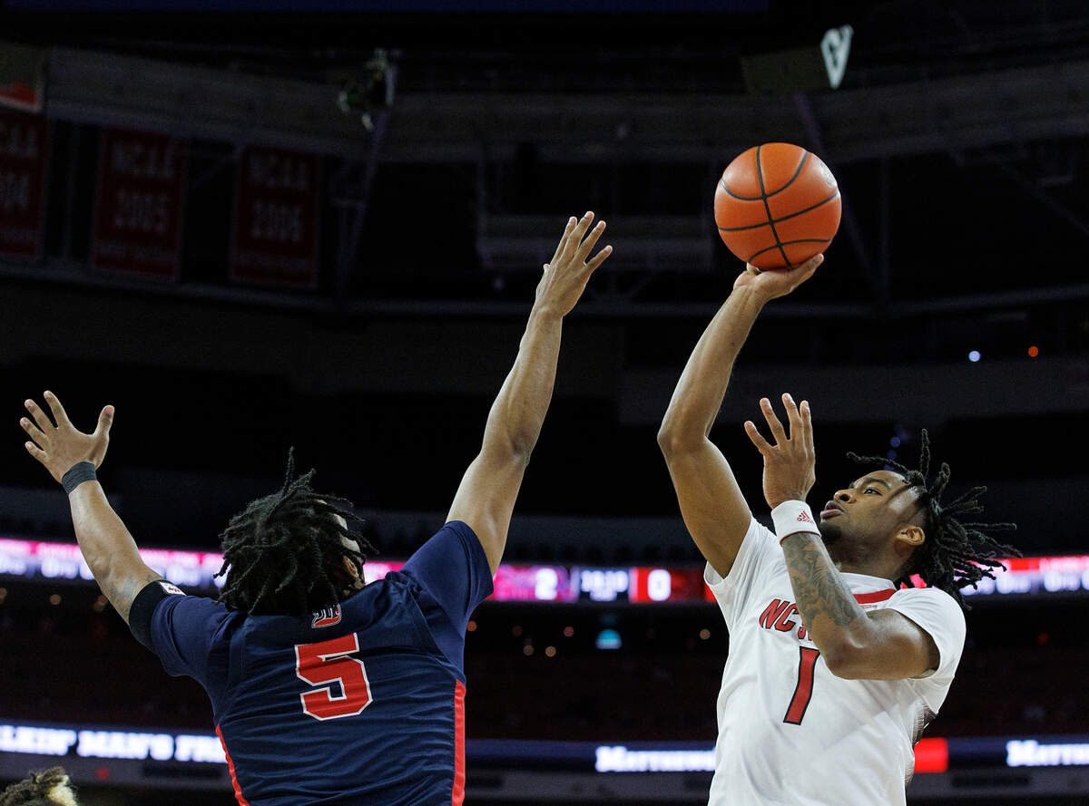 N.C. State’s Jayden Taylor puts up a shot over Detroit’s Kyle LeGreair during the first half of the Wolfpack’s 83-66 win on Saturday, Dec. 23, 2023, at PNC Arena in Raleigh, N.C.