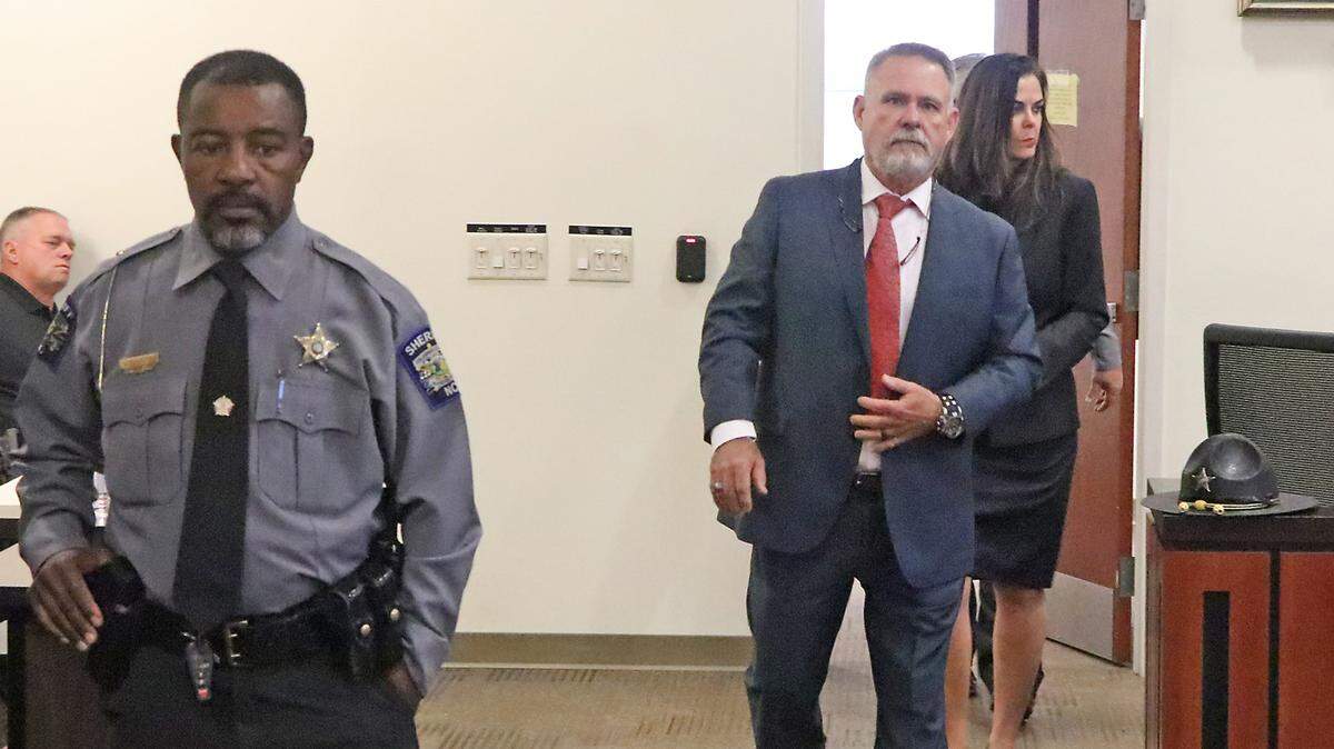 Jody Greene enters a courtroom in the Columbus County Courthouse Monday morning for a removal hearing. He is followed by his wife, Angela Greene.
