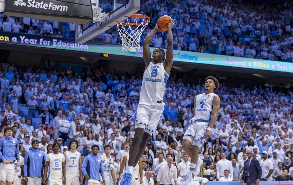 North Carolina forward Caleb Wilson (8) soars to the rim for a dunk, scoring his 24th point and sealing the Tar Heels’ 87-74 victory over Kansas on Friday, November 7, 2025 at the Smith Center in Chapel Hill, N.C.