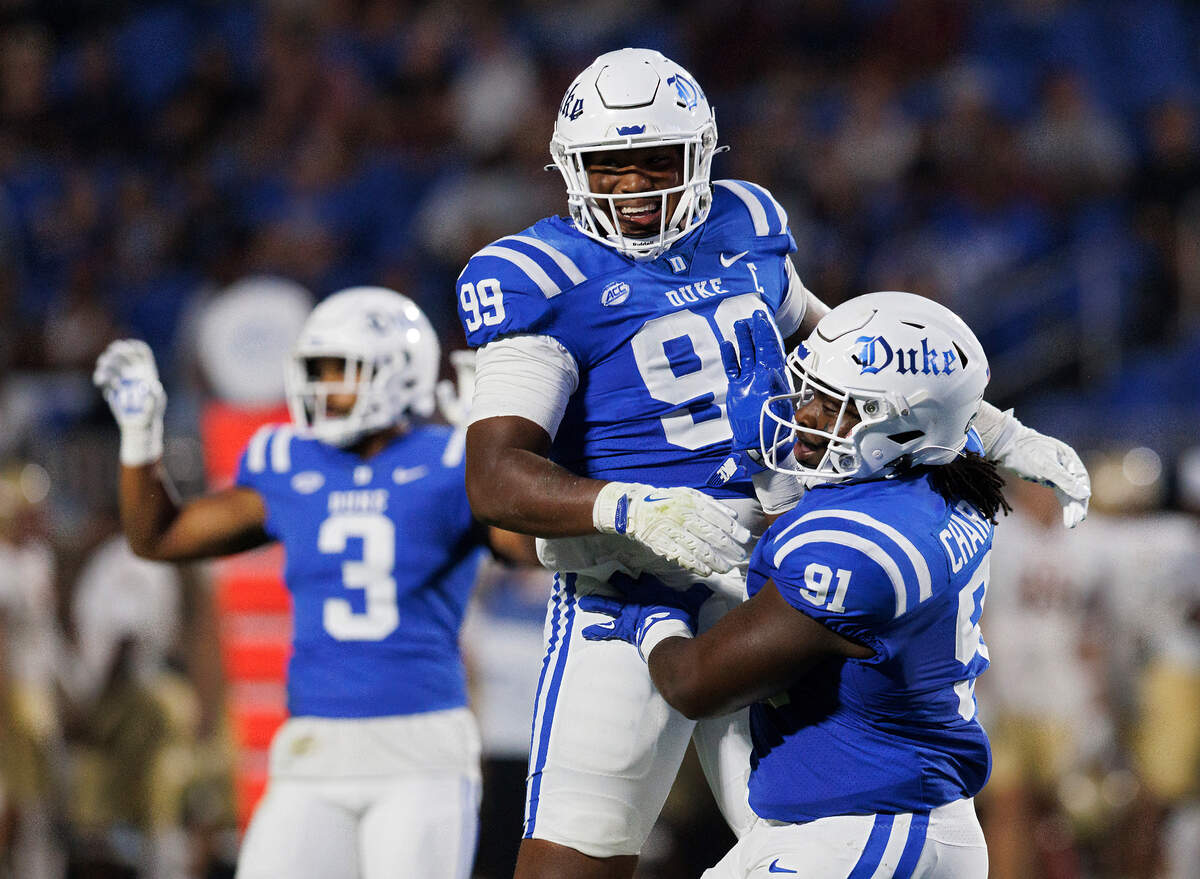 Duke’s Aaron Hall and Kendy Charles celebrate following a defensive stop during the first half of the Blue Devils’ season opener against Elon on Friday, Aug. 30, 2024, at Wallace Wade Stadium in Durham, N.C.
