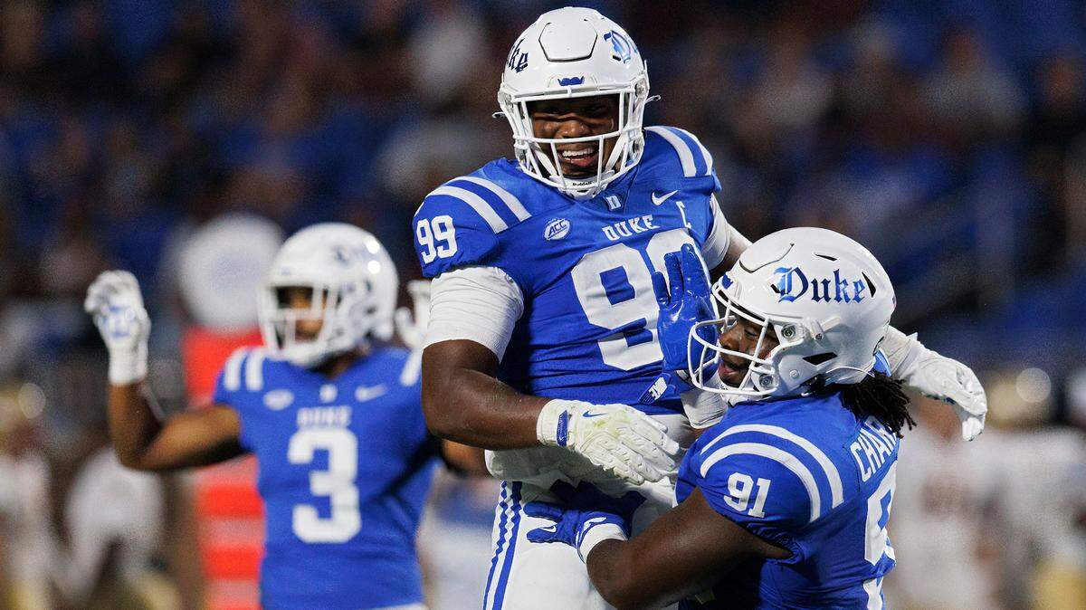 Duke’s Aaron Hall and Kendy Charles celebrate following a defensive stop during the first half of the Blue Devils’ season opener against Elon on Friday, Aug. 30, 2024, at Wallace Wade Stadium in Durham, N.C.
