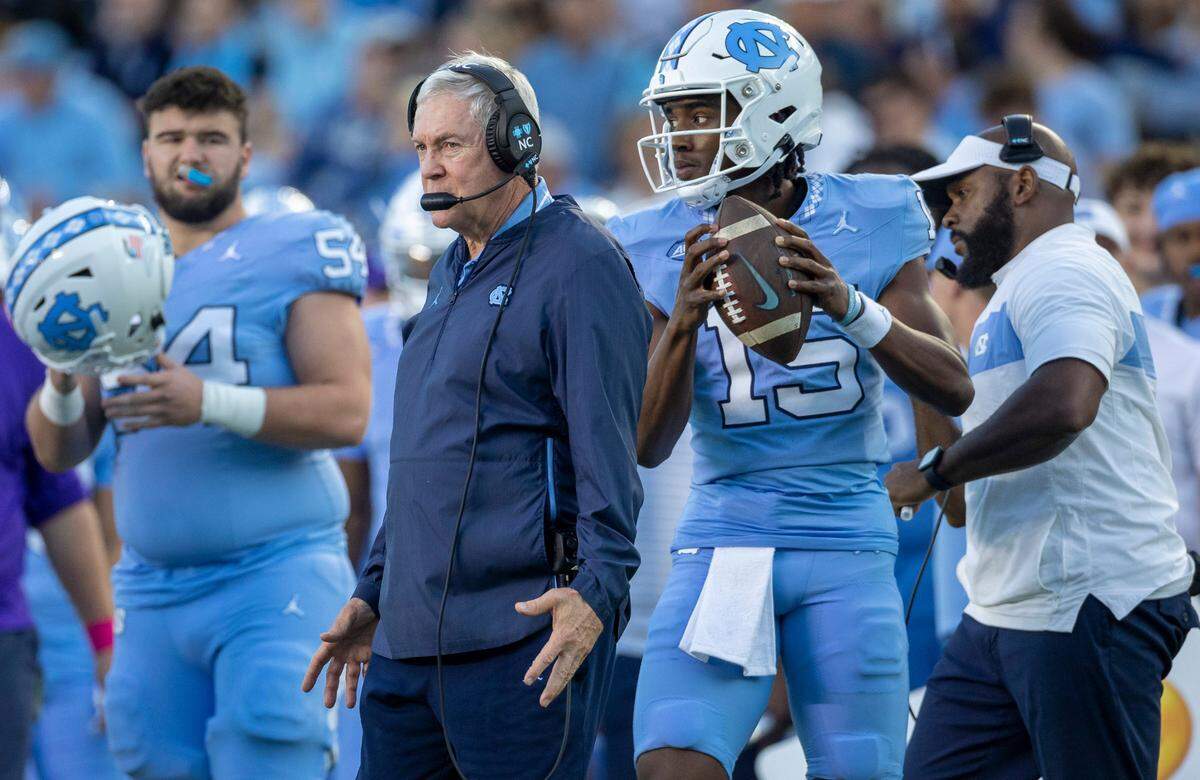 North Carolina reserve quarterback Conner Harrell (15) warms up beside coach Mack Brown, to replace Drake Maye during the fourth quarter against Syracuse on Saturday, October 7, 2023 at Kenan Stadium in Chapel Hill, N.C.