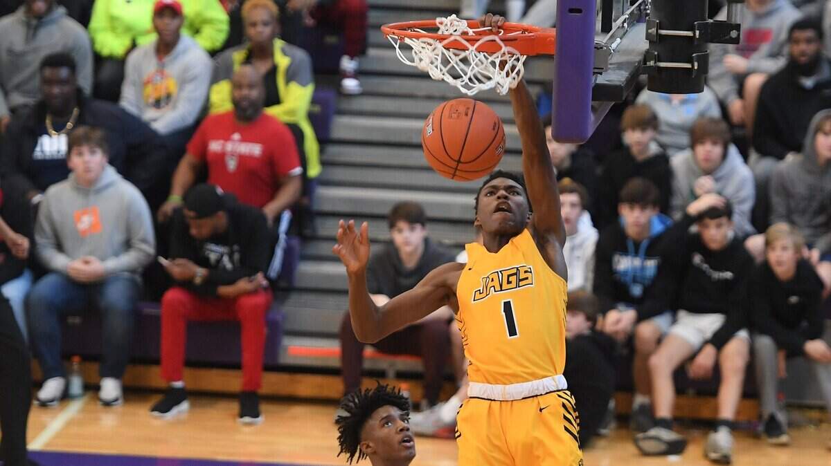 Terquavion Smith (1) of Farmville Central dunks for two points against Naikeed Thomas, left, of Broughton. The Farmville Central Jaguars played the Broughton Capitals in a boys basketball game that was part of the John Wall Holiday Invitational on December 26, 2019.