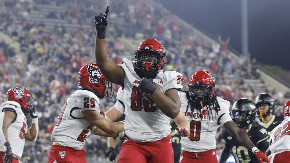 N.C. State defensive end Isaiah Shirley celebrates after returning an interception for a touchdown during N.C. State’s game against Wake Forest on Sept. 11, 2025.