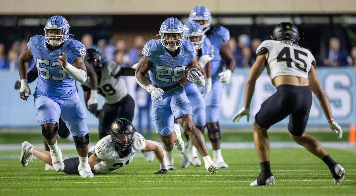 North Carolina running back Omarion Hampton (28) looks for running room on a 20-yard run in the first quarter against Wake Forest on Saturday, November 16, 2024 at Kenan Stadium in Chapel Hill, N.C.