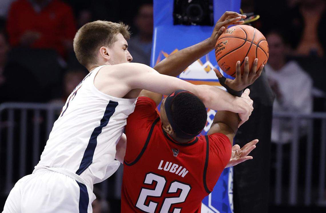 Virginia's Owen Odom (22) fouls N.C. State's Ven-Allen Lubin (22) during the first half of N.C. State’s game against Virginia in the quarterfinals of the 2026 ACC Men’s Basketball Tournament at the Spectrum Center in Charlotte, N.C., Thursday, March 12, 2026.