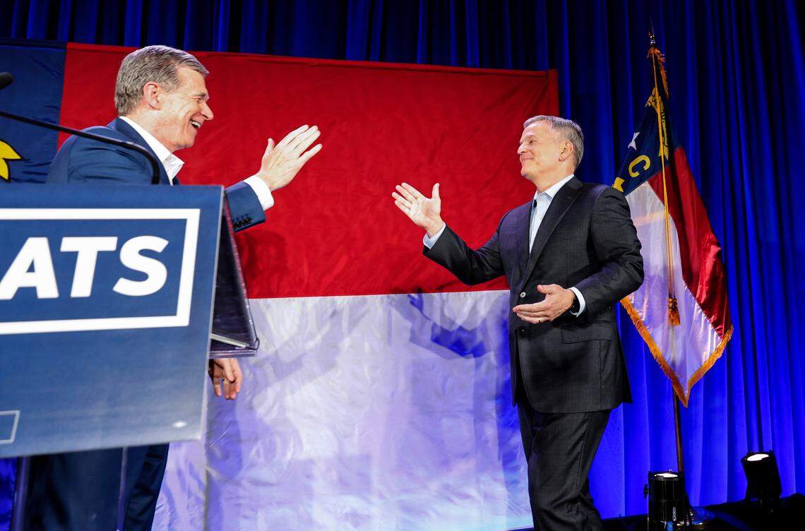 Gov. Roy Cooper greets governor-elect Josh Stein during a North Carolina Democratic Party election night event at the Marriott City Center in Raleigh, N.C., Tuesday, Nov. 5, 2024.