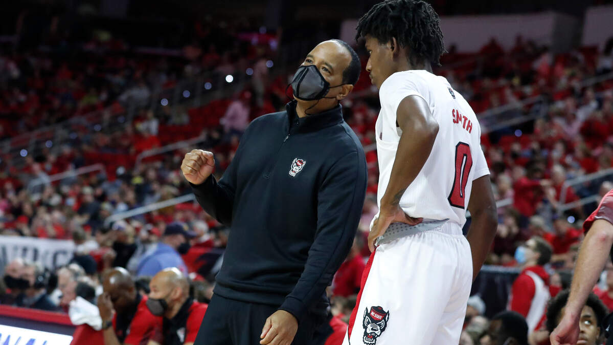 N.C. State head coach Kevin Keatts talks with Terquavion Smith (0) during the second half of Louisville’s 73-68 victory over N.C. State at PNC Arena in Raleigh, N.C., Saturday Dec. 4, 2021.