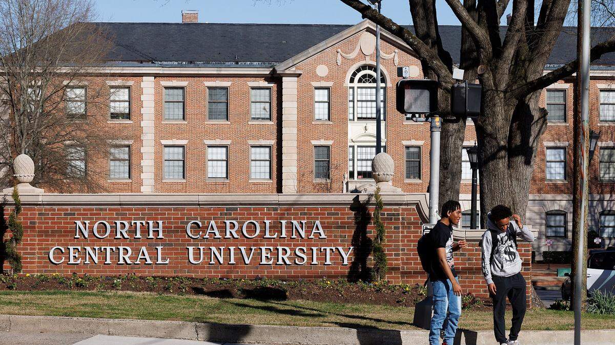 People wait to cross Fayetteville Street on the campus of North Carolina Central University on Tuesday, March 12, 2024, in Durham, N.C.