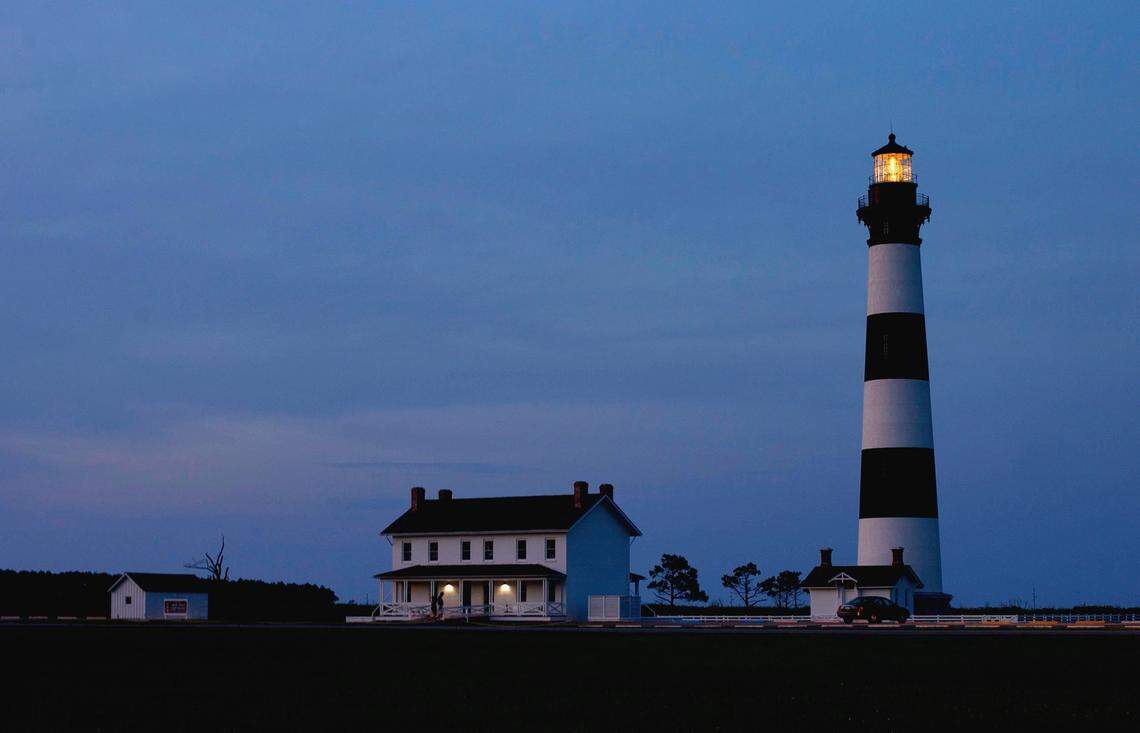 The Bode Island Lighthouse is illuminated as dusk falls on Monday, June 15, 2015 at the Cape Hatteras National Seashore on the outer banks of North Carolina.