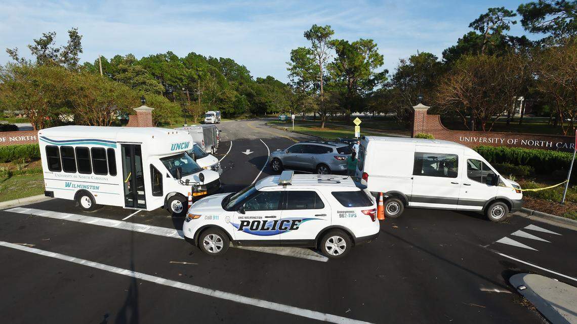 A campus police car and UNC-Wilmington vehicles block the entrance to the university Monday in Wilmington, N.C. UNC-Wilmington posted a message Monday saying the campus would not reopen this week and that a firm date for reopening has not been set.