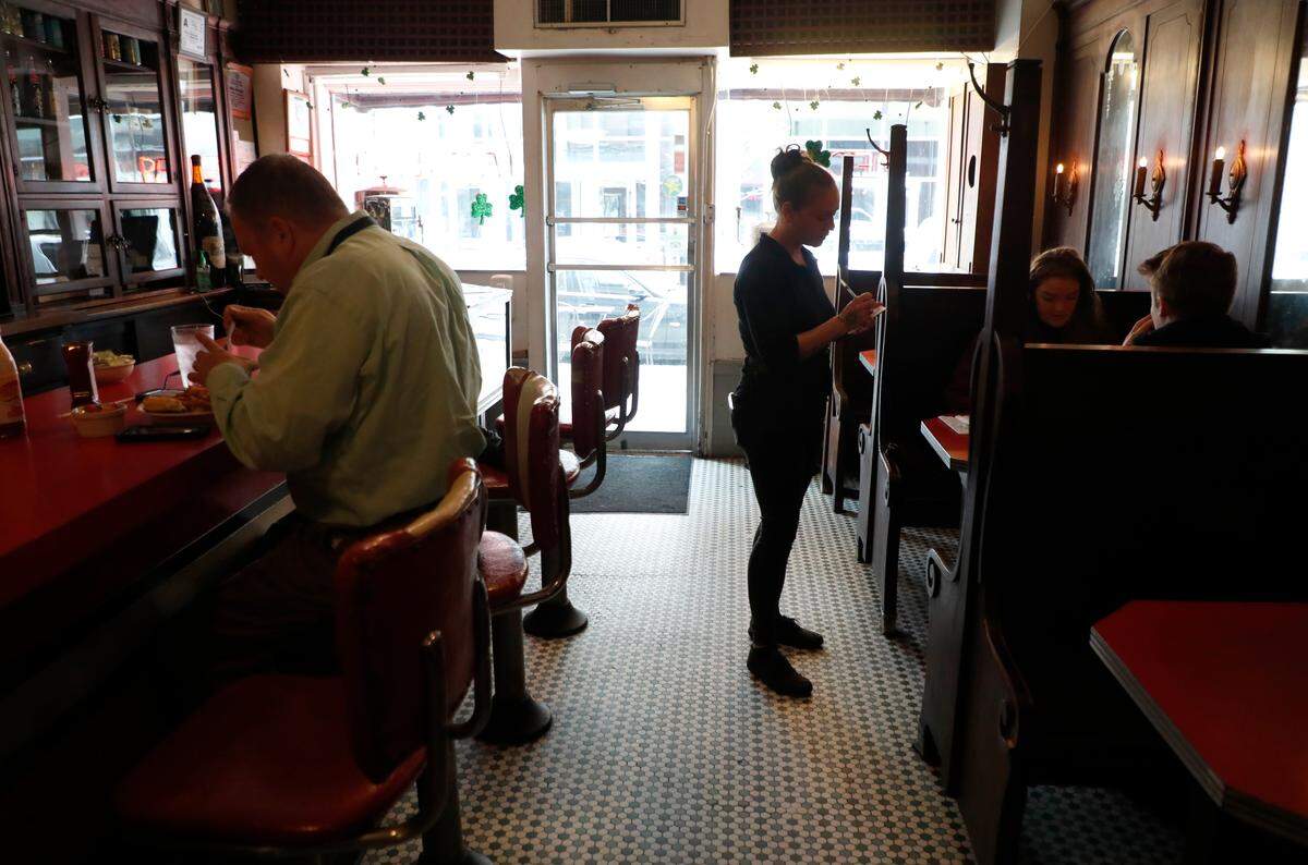 Carla Edge takes lunch orders at Mecca Restaurant in Raleigh in Raleigh, N.C., Tuesday, March 17, 2020. Gov. Roy Cooper ordered bars and restaurants to close at 5 p.m. Tuesday, except for take-out and delivery. Mecca Restaurant will offer curbside pickup and delivery via DoorDash.